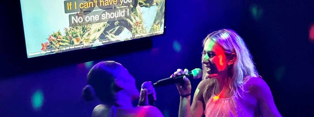 Singer on the mic in the private karaoke room at Spinners Maroochydore
