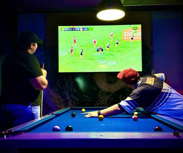 Watching live sport on the big screen while playing pool at Spinners